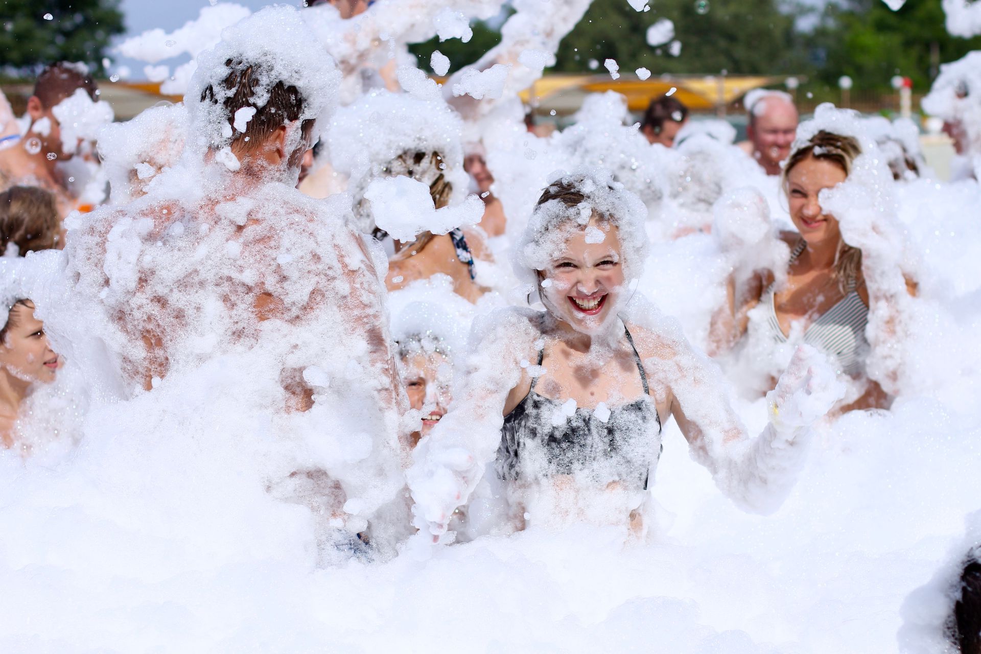 Kids covered in foam laughing at a Maine Foam Parties event